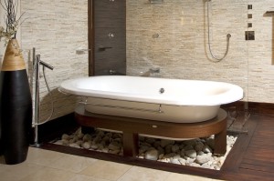 Surprising-luxurious-bathroom-design-eastern-style-with-white-unique-free-stand-bathtub-also-hardwood-flooring-and-white-rocks-also-and-cool-unique-faucet-hand-shower-design-ideas